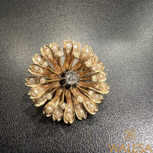 Broche en or jaune 18K sertie d’un diamant central